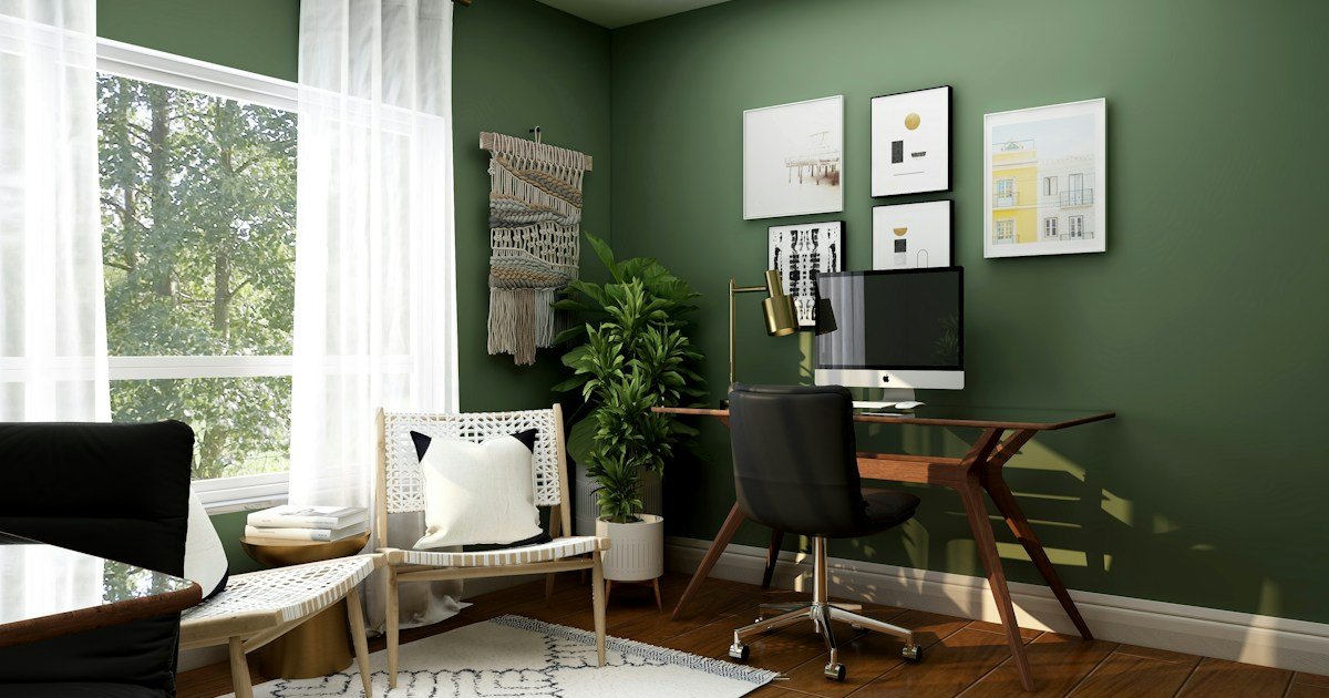 Bright home office with wood desk, chair and green walls illustrating home office demand among new-home buyers