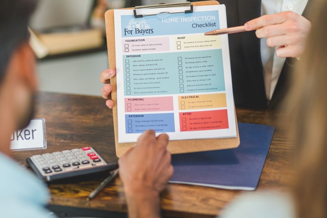 Real estate consultant reviewing documents and pricing with clients